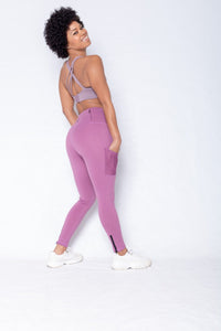 Shakolo adjustable strap bra in purple and high waist leggings in purple back view with model looking back
