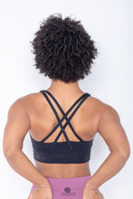 Load image into Gallery viewer, Shakolo crossover bra in black and high waist leggings in purple back view model with arms on top of butt