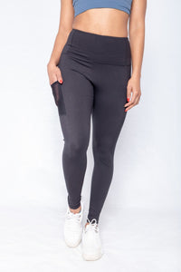 Shakolo high neckline bra in dark blue and high waist leggings front view with hand in a pocket