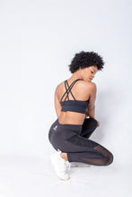 Load image into Gallery viewer, Shakolo crossover bra in black and mid waist leggings in black back view model squating