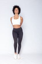 Load image into Gallery viewer, Shakolo crossover bra in white and mid rise leggings in black front view model holding hands behind back