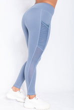 Load image into Gallery viewer, Shakolo mid rise leggings in blue side view with one leg backward
