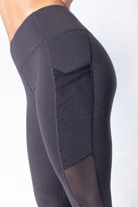 Shakolo mid waist leggings in black side view close up with mesh side